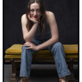 Maddie Studio Portrait Sitting on Bench with Smirk